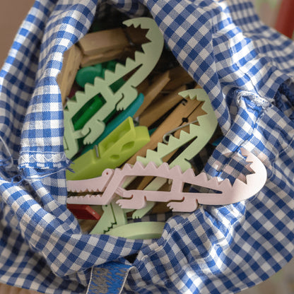 Krokoclip clothes peg in a crocodile design in vibrant green, made of plastic, against a light background.